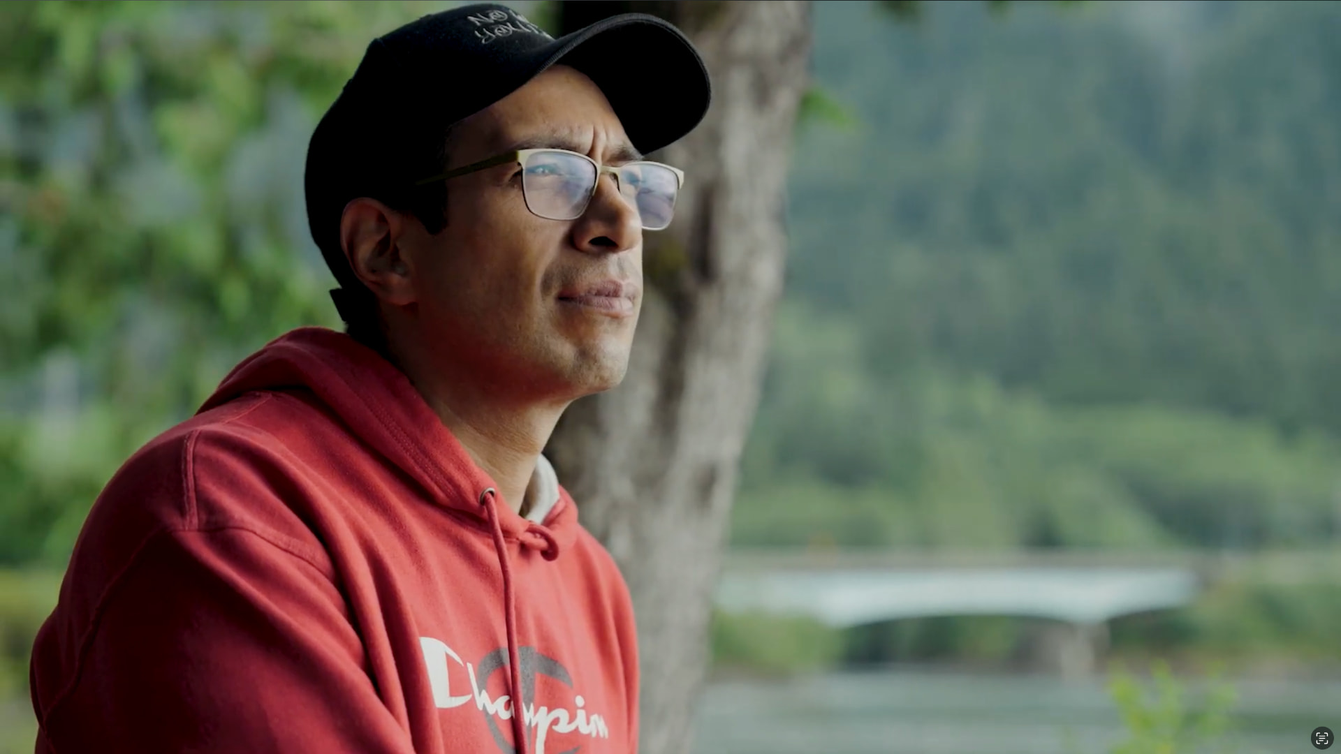 CMHA documentary production — man in red hoodie outdoors by a lake